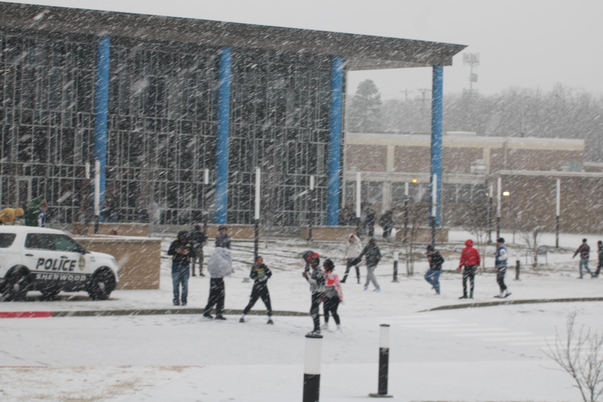 Students enjoy fresh snow in the courtyard. 