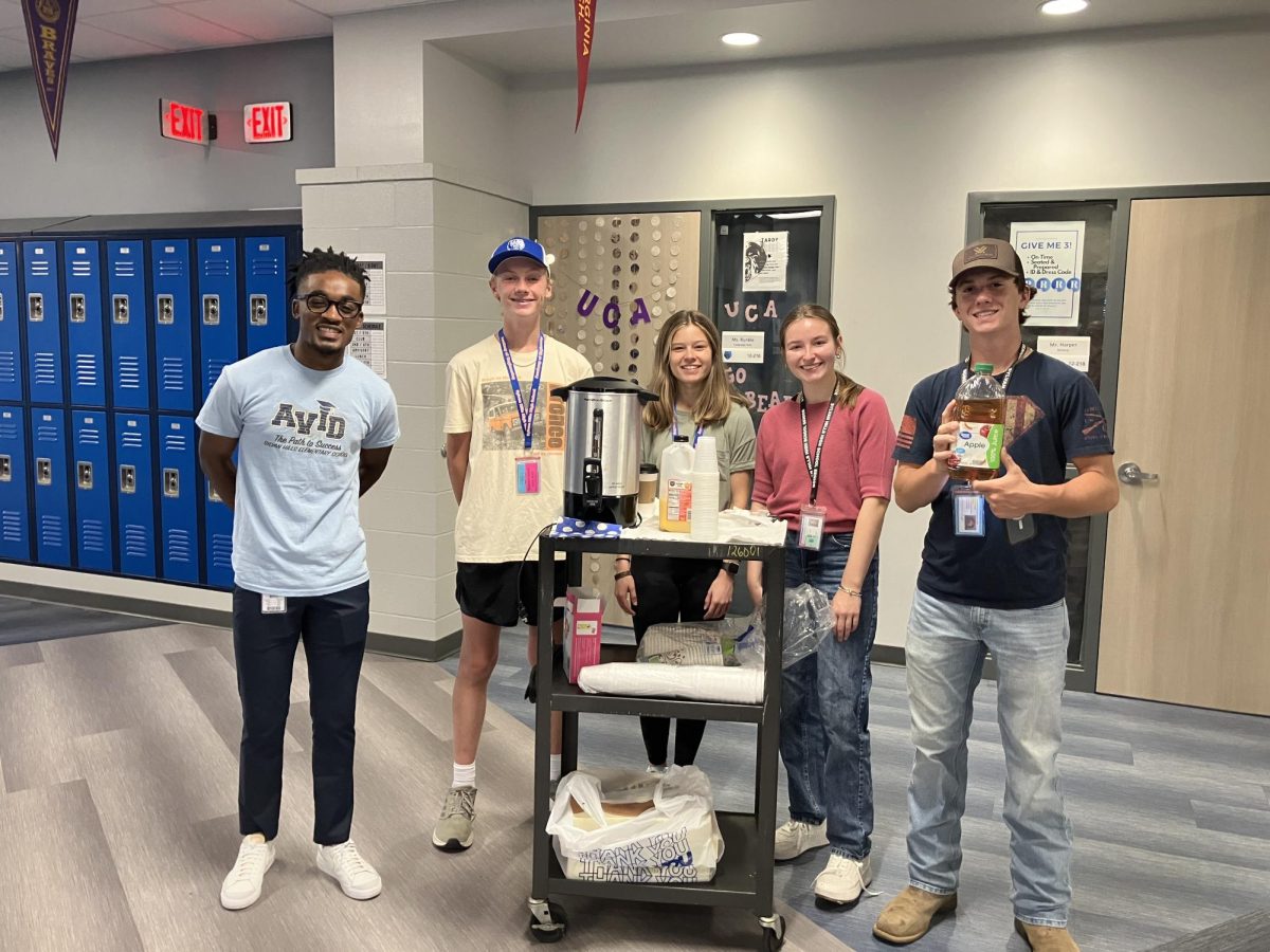 Senior Kamorean Matthews, Sophomore Ty Harper, Sophomore Peyton Zermatten, Senior Emma Black, and Senior Eli Steele distribute breakfast snacks and drinks to teachers.