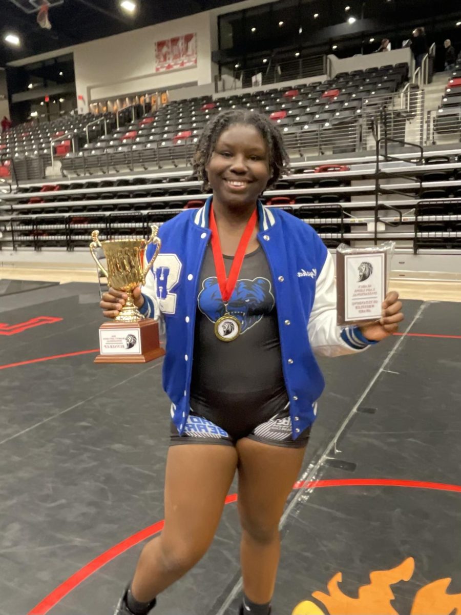 Senior DMysha James stands holding 2nd place Team Trophy (left) and her Most Outstanding Female wrestler plaque 
(right). The Lady Bears finished 2nd in State this season. DMysha won 5 OFW plaques this season and finished 60-0  on her way to finishing top in the State.