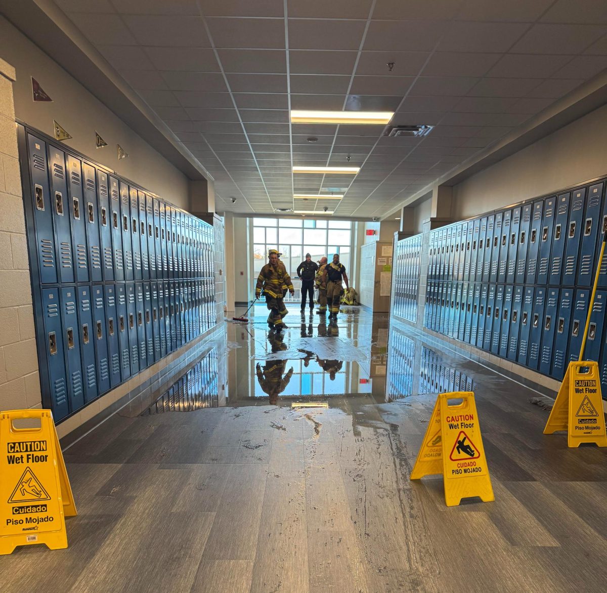 Fire fighters assist in securing the building 12 English hallway. 