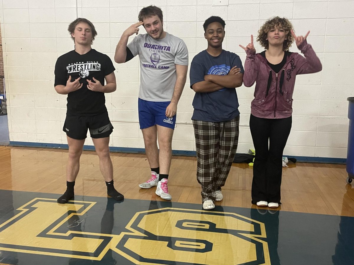 Seniors Zion Mansfield, Gavin Milby, Adrian York, and Riley Faizo share light poses for the camera before gearing up for practice in the old Gym.