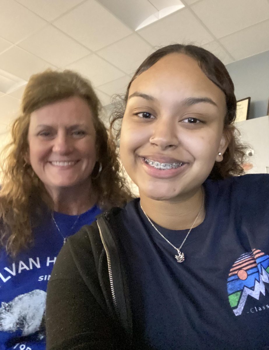 Mrs. Scallon poses with Senior Kylisia Robinson in Mr. Scroggins' room . Mrs. Scallon got into teaching due to her love for athletics. She now enjoys teaching English.