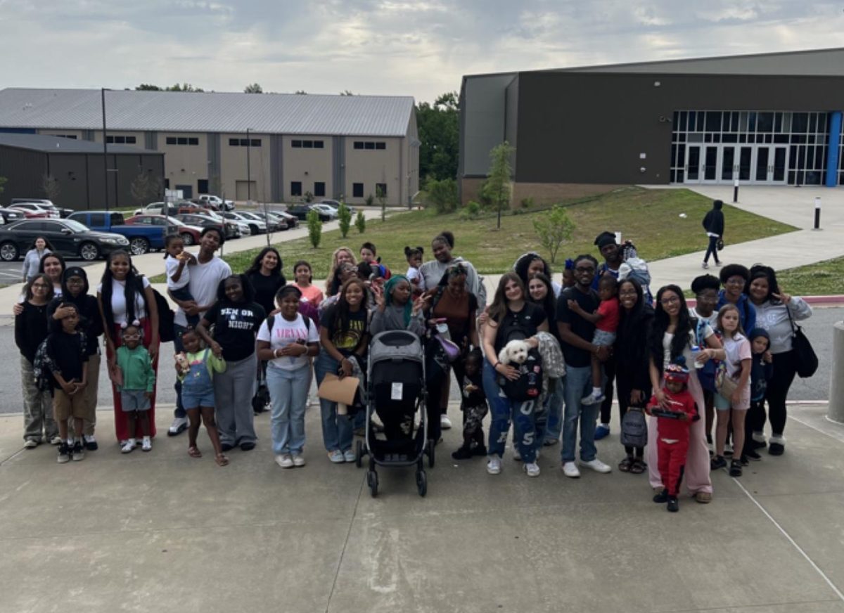 Seniors line up with their siblings for a photo after having performed the 'prank' of bringing siblings, or in one case a dog, to school. This type of prank appeared inspired by other seniors performing the same prank on social media.