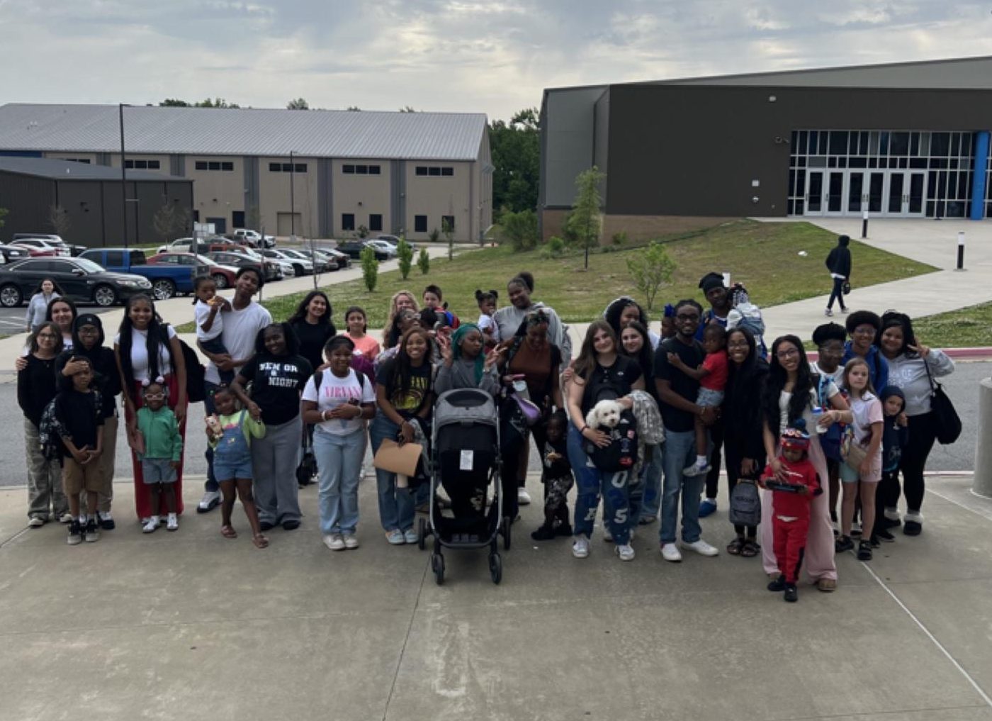 Seniors line up with their siblings for a photo after having performed the 'prank' of bringing siblings, or in one case a dog, to school. This type of prank appeared inspired by other seniors performing the same prank on social media.