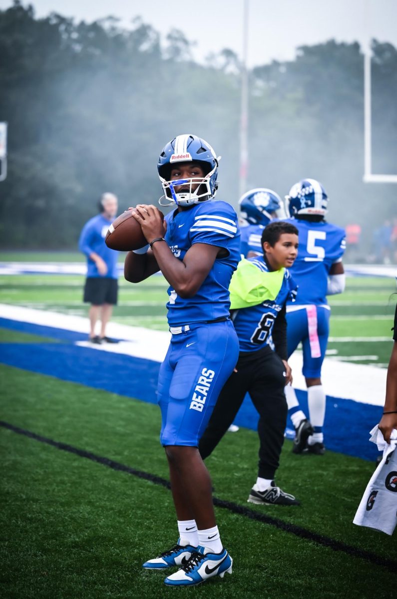 Quarterback Tyler Hampton (12) warms up for the big game against Maumelle.