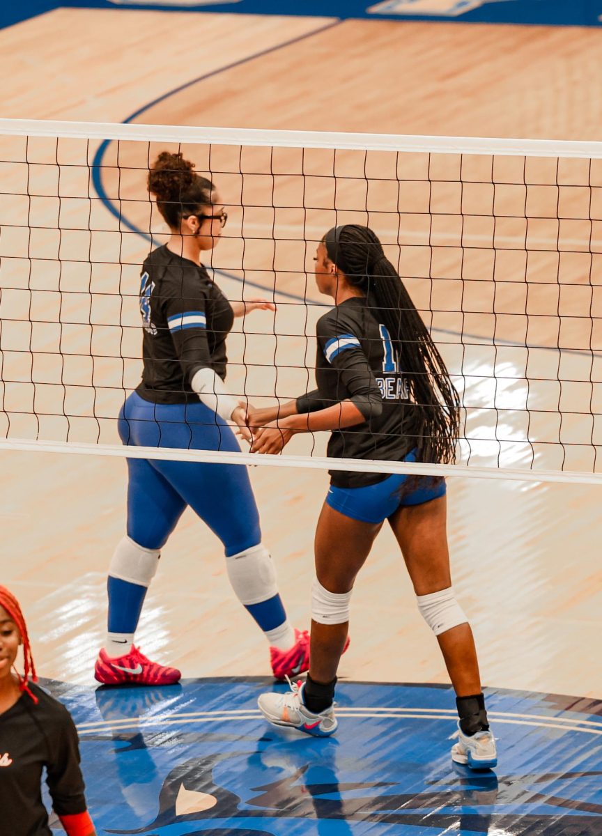 Ava Franklin (11) celebrates with Paris Wilburn (11) after Paris scores a point. The Bears defeated Jacksonville 3-0. 