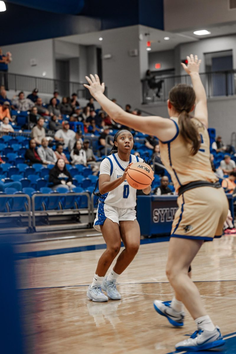 Nia Herd-Thomas (12th) shoots the ball over a defender vs. Sheridan. Lady Bears won the game 60-48.