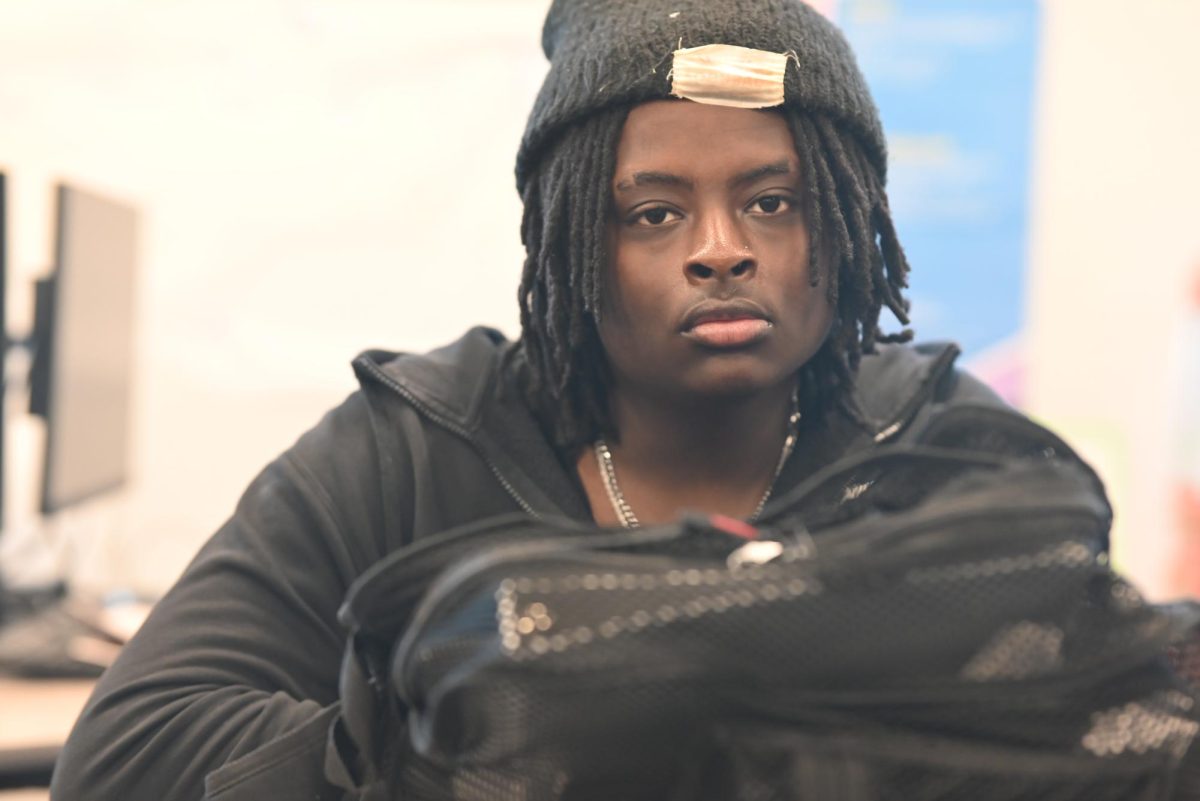 Packed up and ready to go-- Ahaziah Kirkwood (12) takes a moment after packing his bag for home, awaiting the final announcements and bell. 