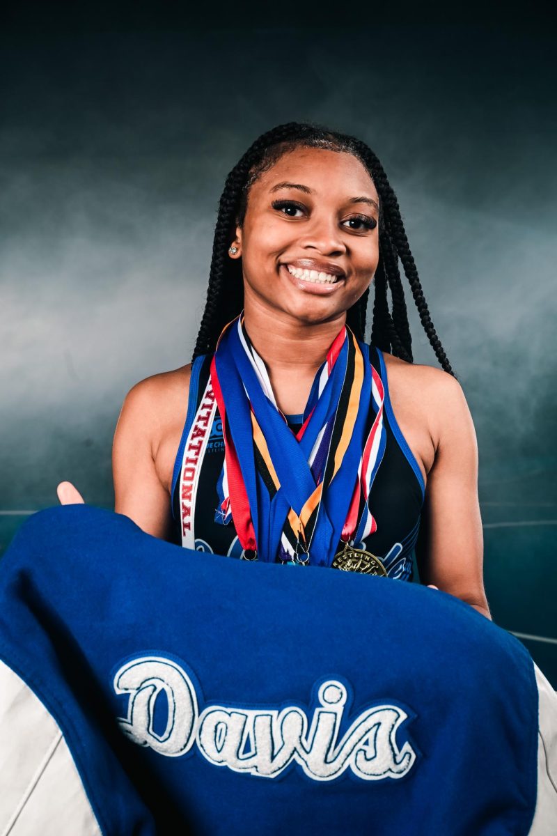 Junior Jer'Leah Davis poses during Media Day with the medals she earned through a season of competition. Photo provided by Jer'Leah Davis. 