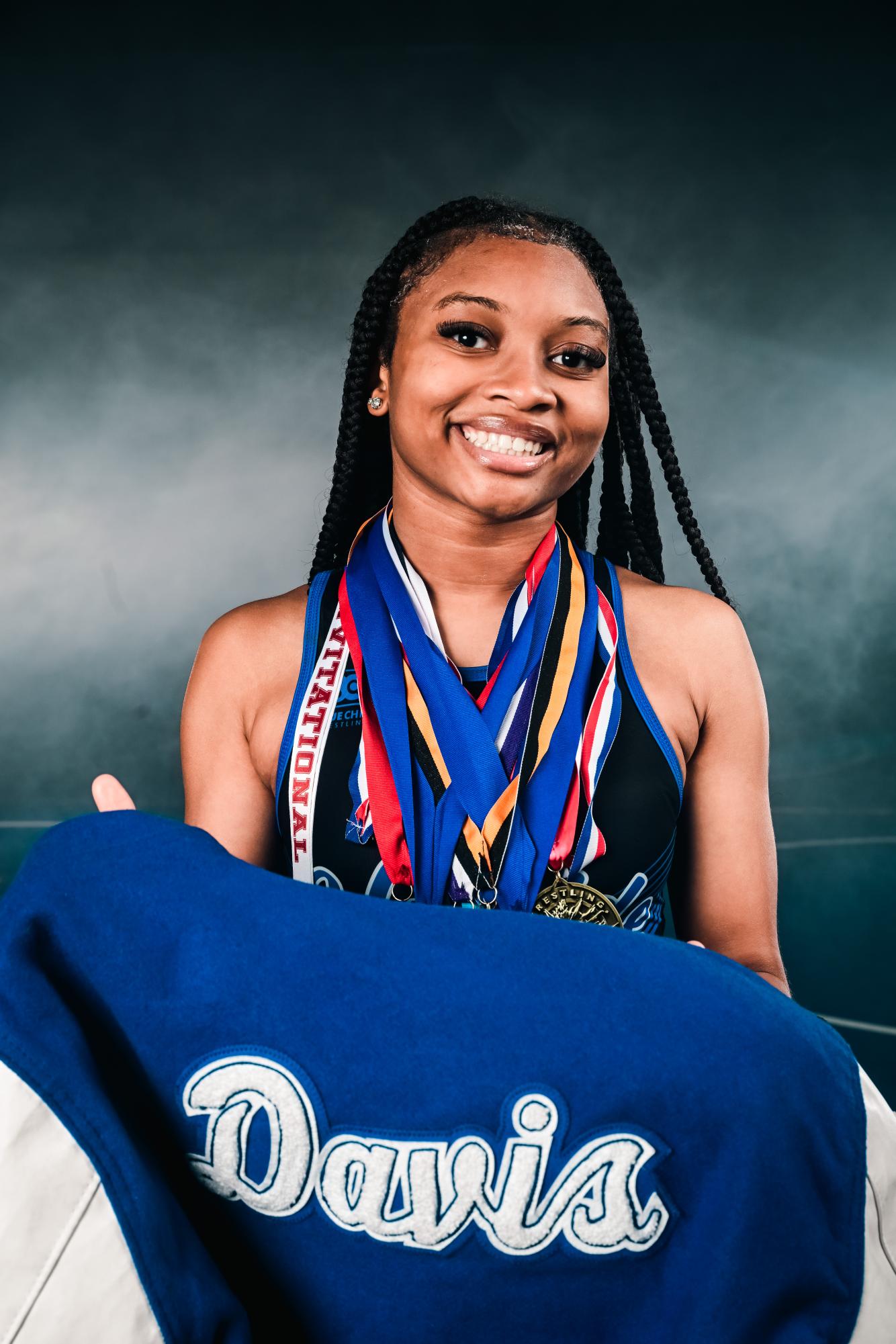 Junior Jer'Leah Davis poses during Media Day with the medals she earned through a season of competition. Photo provided by Jer'Leah Davis. 