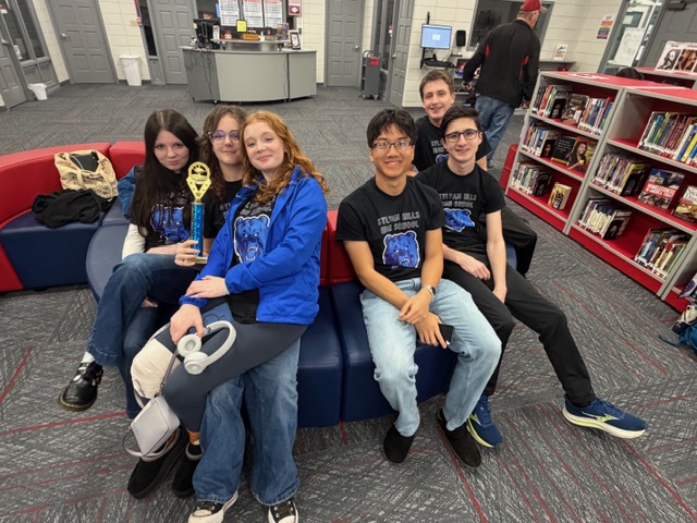 Quizbowl participants Ava Hendrickson (12), Hailey Middaugh (12), Lillian Morkell (10), Nathan Lam (12), Nicolai Grishanor (11), and Abram McGinty (10) huddle together after placing 4th in their recent competition at Marion. The win qualified them for state. 