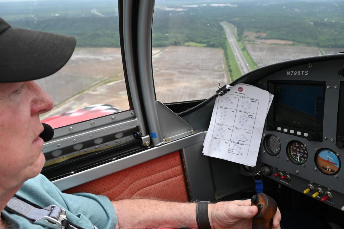 An EAA volunteer flies over Conway as he communicates to other pilots. Students interested in flight can join Aviation Club during Club Rush in the fall. 