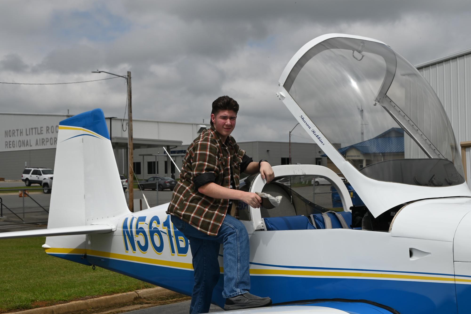 Sophomore Liam Fisher pauses for a photo near a Vans RV aircraft as he prepares for a Young Eagles flight at North Little Rock Municipal Airport. Students interested in flight can join Aviation Club each fall during Club Rush.
