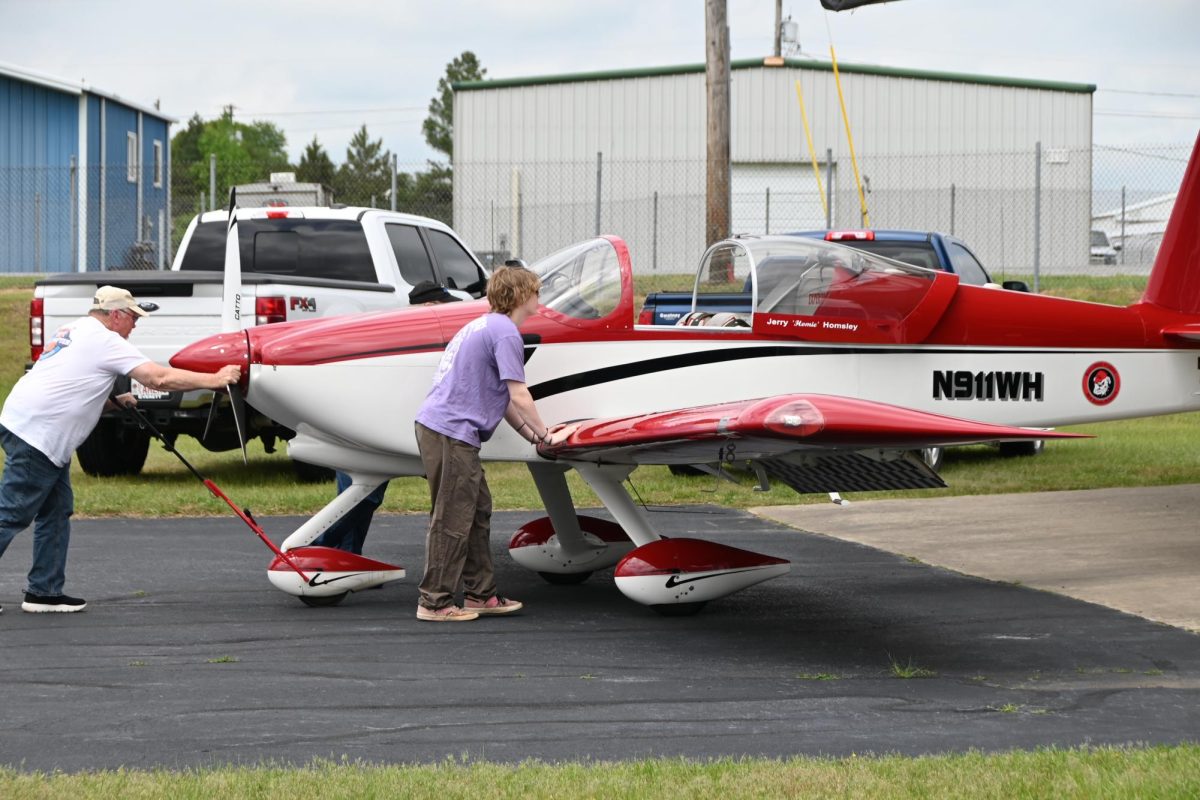 Junior Jonah Freshley helps Mr. Homesley push the Vans RV aircraft back to the hanger. 