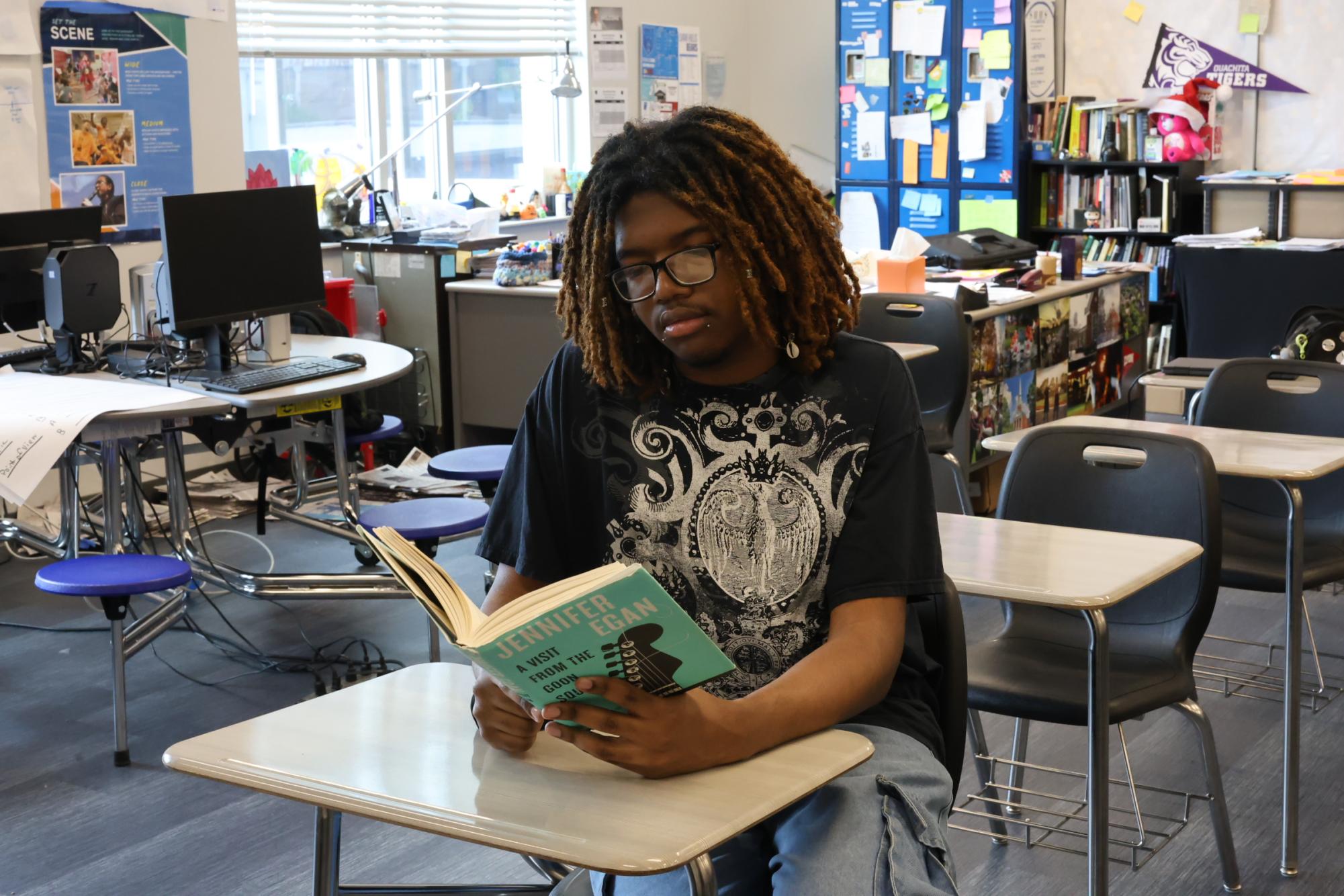 Senior Te'Shawn White checks out book from Journalism class. White really enjoyed Film Society this year.