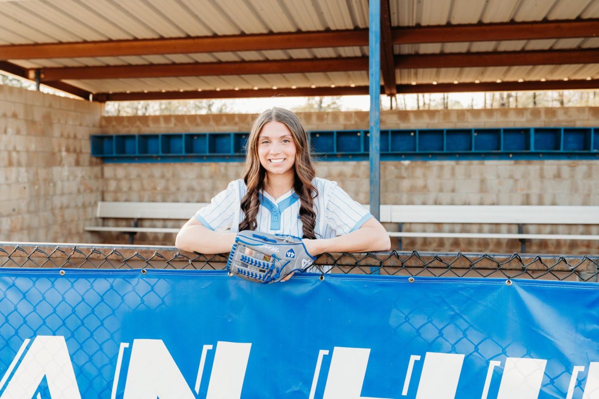 Abigail Mayden poses for a senior photo at the softball field. 
