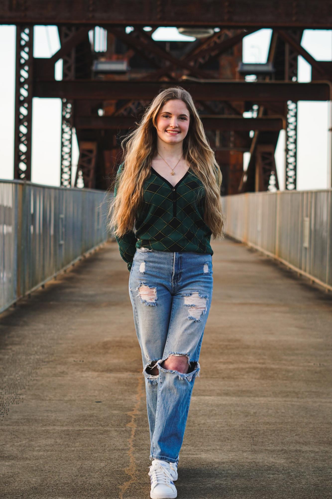Senior Emily White poses for a senior photo along a local Arkansas bridge. Photograph courtesy of Emily White. 