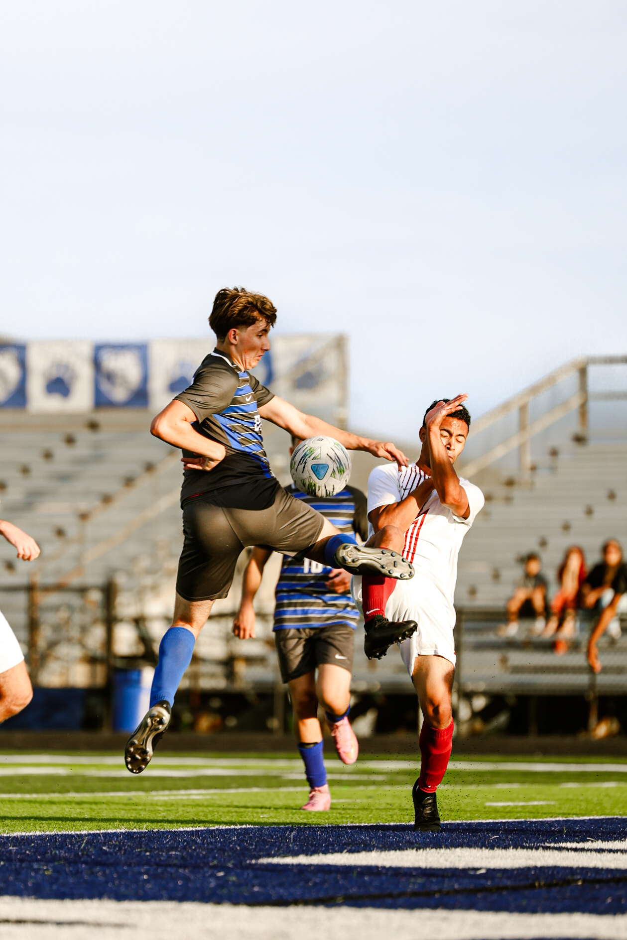 Senior Maddox Voss leaps into the air to control the ball and pass it to his teammates.