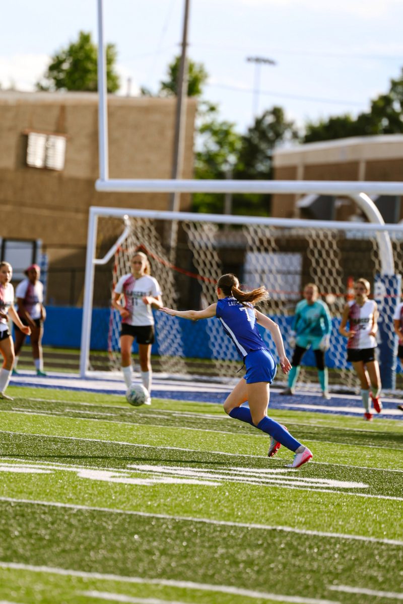 Macie Copeland (11) runs towards the ball to pass up midfield.