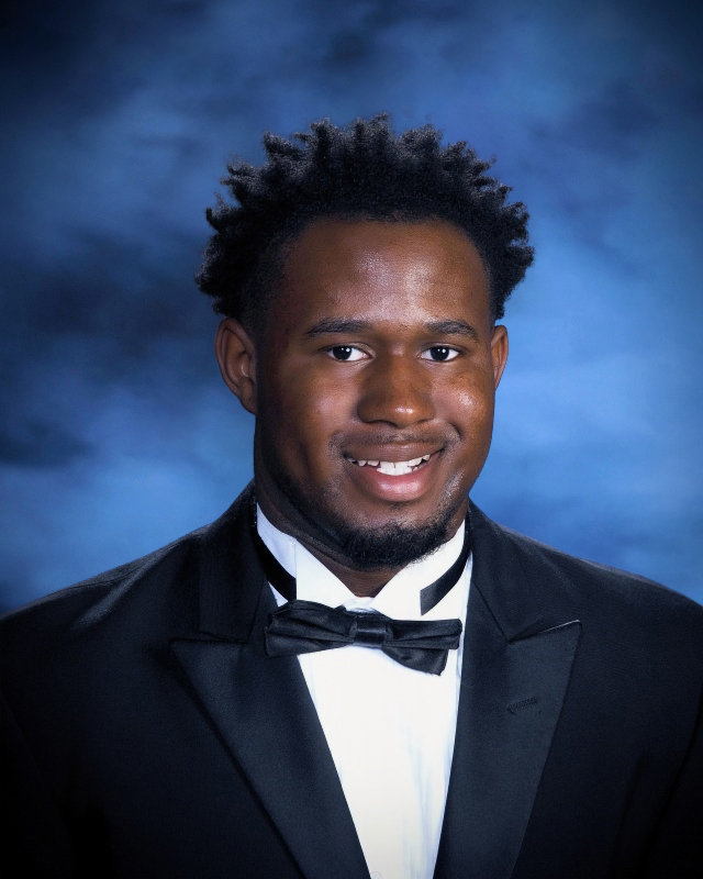 Senior Kaedon Curtis smiles during a senior photo.  Curtis enjoyed sports and theatre during his time at Sylvan Hills. He hopes people will remember him for giving it his all and never complaining. Photograph provided by Prestige Photography. 